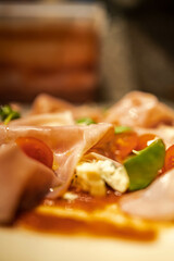 Detailed view of a pizza slice loaded with toppings. Ideal for menu close-ups or food promotions.