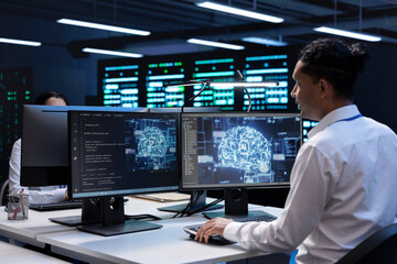 Engineer does maintenance on server hub to optimize it for data processing requirements of...