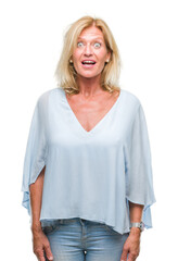 Fototapeta premium Middle age blonde business woman over isolated background afraid and shocked with surprise expression, fear and excited face.