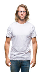Fototapeta premium Young handsome man with long hair wearing glasses over isolated background with serious expression on face. Simple and natural looking at the camera.
