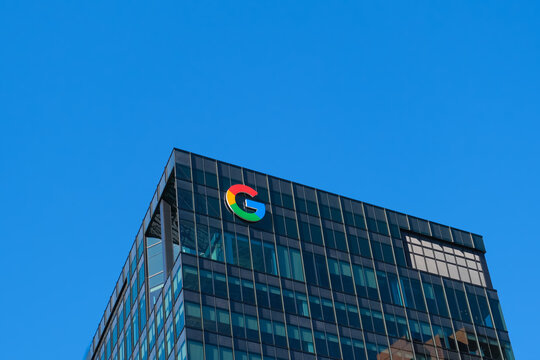 Cambridge, USA - 12 October 2024. modern building displaying Google's iconic logo against a bright blue sky. innovative and global presence of one of the leading technology companies in the world.