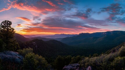 Obraz premium A Panoramic View of a National Park at Sunrise, With Vibrant Colors in the Sky, Mountains, and Lush Forests 