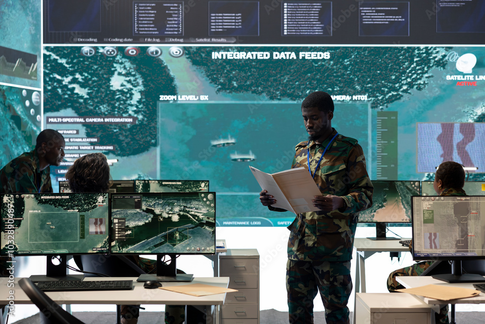 Poster special operations engineer reading new mission case file brief in control room, working with real t