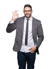Young handsome business man over isolated background smiling positive doing ok sign with hand and fingers. Successful expression.