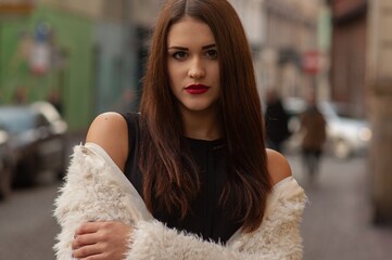 Close up trendy portrait of elegant young woman with big eyes and red lips
