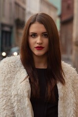 Close up trendy portrait of elegant young woman with big eyes and red lips