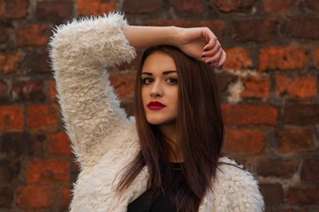 Close up trendy portrait of elegant young woman with big eyes and red lips