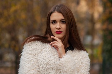 Close up trendy portrait of elegant young woman with big eyes and red lips