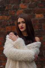 Close up trendy portrait of elegant young woman with big eyes and red lips