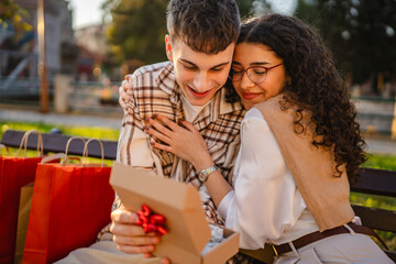 boyfriend surprise girlfriend with special gift after shopping outdoor