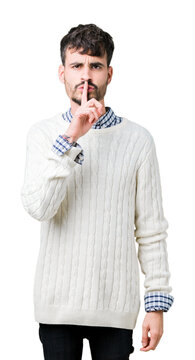 Young handsome man wearing winter sweater over isolated background asking to be quiet with finger on lips. Silence and secret concept.