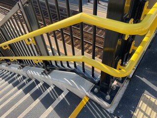 Yellow handrails and non-slip stairs on new staircase at railway station