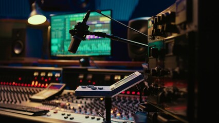 Control room desk equipped with motorized faders and amplifier used in mixing and mastering tracks...