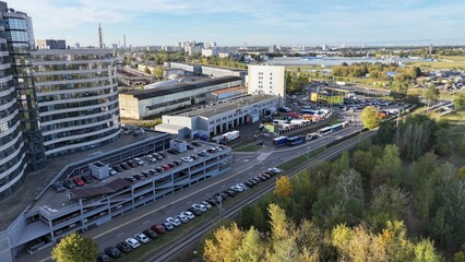 Minsk, Belarus - 27.10.2024: The outskirts of Minsk in the fall, a large metropolis, a view from a height. The area behind the ring road of Minsk. Storage warehouses, repair depots, private buildings.