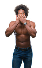 Fototapeta premium Afro american shirtless man showing nude body over isolated background shocked covering mouth with hands for mistake. Secret concept.
