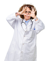 Middle ager senior doctor woman over isolated background Doing heart shape with hand and fingers smiling looking through sign