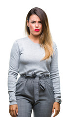 Obraz premium Young beautiful worker business woman over isolated background skeptic and nervous, frowning upset because of problem. Negative person.