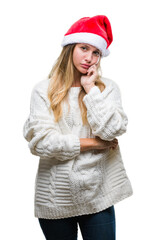 Young beautiful blonde woman wearing christmas hat over isolated background thinking looking tired and bored with depression problems with crossed arms.