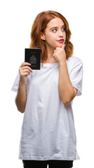 Young beautiful woman holding passport of canada over isolated background serious face thinking about question, very confused idea