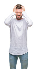 Fototapeta premium Young handsome man over isolated background suffering from headache desperate and stressed because pain and migraine. Hands on head.