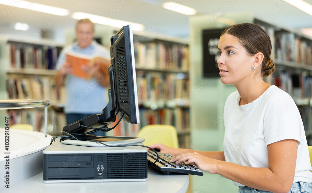 Poster focused female student in casual clothes, typing on keyboard request while searching information in 