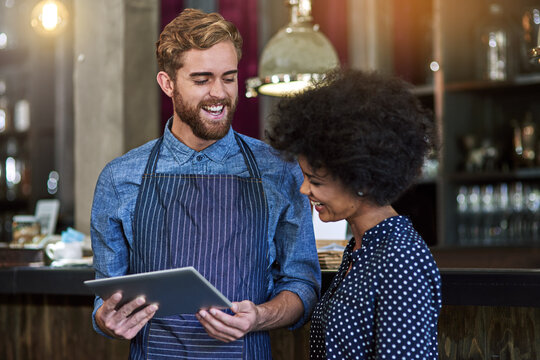 Waiter, woman and happy with tablet in cafe for showing online menu, hospitality and help with decision. Barista, people and smile with digital app in coffee shop for order choice or customer service