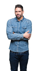 Fototapeta premium Young handsome man over isolated background skeptic and nervous, disapproving expression on face with crossed arms. Negative person.