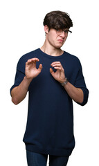 Young handsome man wearing glasses over isolated background disgusted expression, displeased and...