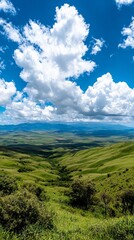 Fototapeta premium Rolling green hills stretch out under a bright blue sky with fluffy white clouds.