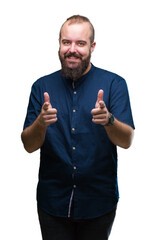 Young caucasian hipster man over isolated background pointing fingers to camera with happy and funny face. Good energy and vibes.