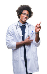 Afro american doctor man over isolated background with a big smile on face, pointing with hand and finger to the side looking at the camera.