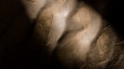 Fototapeta premium Abstract sand dunes in golden light: mysterious shadows and textures.