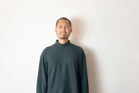 Young asian men wearing winter clothes is sad and crying on isolated white background