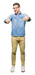 Handsome man wearing glasses approving doing positive gesture with hand, thumbs up smiling and...