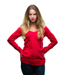 Young beautiful blonde woman wearing red sweater over isolated background skeptic and nervous, frowning upset because of problem. Negative person.