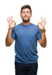 Fototapeta premium Young handsome man over isolated background relax and smiling with eyes closed doing meditation gesture with fingers. Yoga concept.