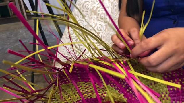 Hat weaving involves creating hats by hand using dried pandan straw native to Indigenous cultures.