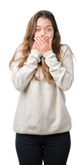 Young beautiful brunette woman wearing turtleneck sweater over isolated background shocked covering mouth with hands for mistake. Secret concept.