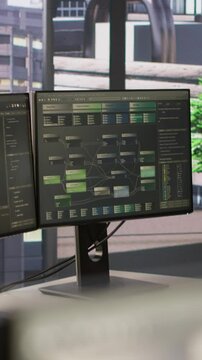 Vertical video Empty IT department office used for building AI neural networks software technology. Close up of computer monitors in company workspace with nobody in and devices left open on desks