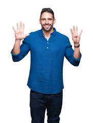 Young handsome man over isolated background showing and pointing up with fingers number nine while smiling confident and happy.