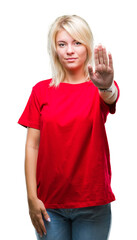 Young beautiful blonde woman wearing red t-shirt over isolated background doing stop sing with palm of the hand. Warning expression with negative and serious gesture on the face.