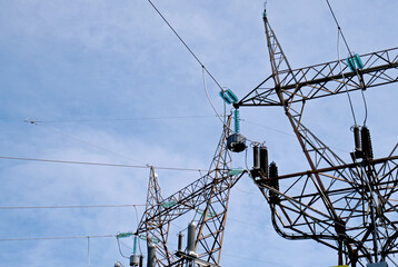 Electricity pylons with a clouded sky in the background