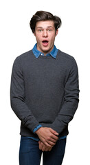 Young handsome elegant man over isolated background afraid and shocked with surprise expression, fear and excited face.