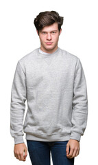 Fototapeta premium Young handsome sporty man wearing sweatshirt over isolated background skeptic and nervous, frowning upset because of problem. Negative person.