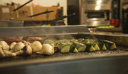 A vibrant close-up of grilled zucchini and mushrooms, showcasing their smoky char and juicy...
