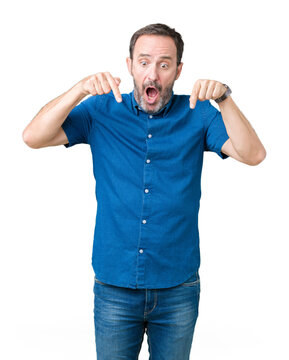 Handsome middle age elegant senior man over isolated background Pointing down with fingers showing advertisement, surprised face and open mouth