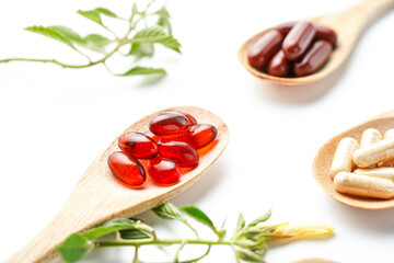 Vitamin capsules in a wooden spoon, soft gels, Fish oil capsules, omega 3, omega 9, vitamin D,...