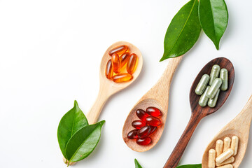 Top view Variety of vitamin and mineral pills in wooden spoon, Dietary supplement healthcare