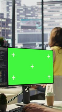 Vertical video Man working with machine learning tech on green screen computer, advancing AI innovating autonomous systems, close up. Zoom in on mockup PC monitor used by IT expert in office, camera B