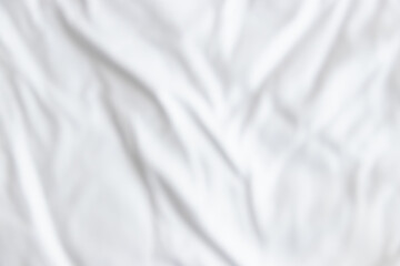 Blurred white wrinkled fabric texture rippled surface and background, Soft focus.